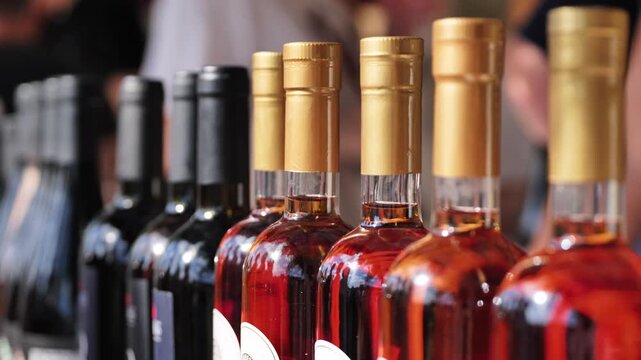 Displaying a row of wine bottles with golden caps offering selection and variety