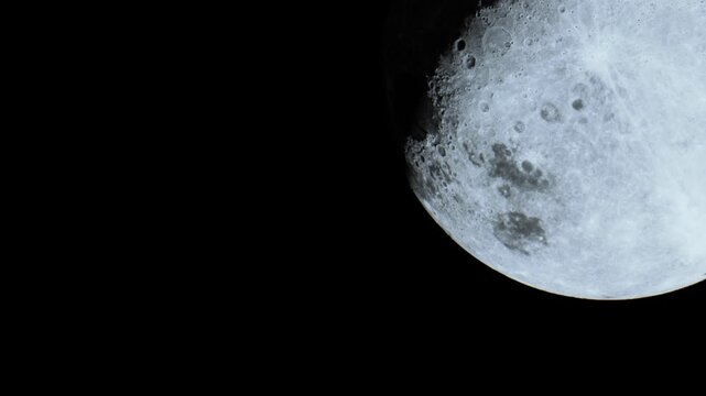 A brilliant full moon illuminates the night sky, showcasing its detailed craters and surface texture. This captivating view invites wonder and reflection on celestial beauty.