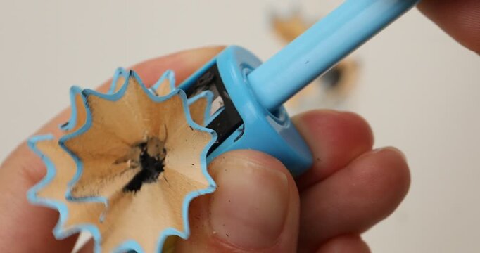 Woman using sharpener on white background, closeup