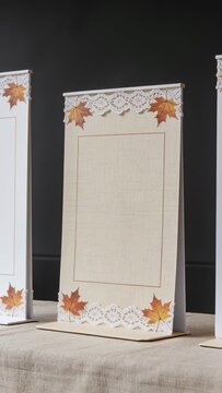 Vertical video: Moving camera showing center tent on beige cloth, revealing lace maple leaf decals