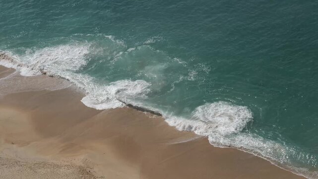 Closer high angle view of large ocean waves flowing at Praia do Norte in Nazar&eacute; Portugal