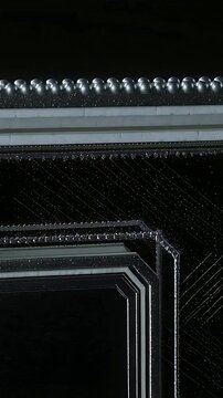 Vertical video: Starting closeup panning camera revealing ornate metal box in studio to show detail