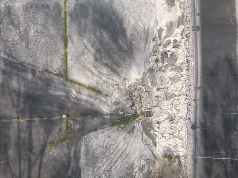 Aerial view of the Brushy Creek Wastewater Treatment Plant showing concrete surfaces, drainage patterns, and vegetation growth in Chirnside Park, Victoria, Australia.