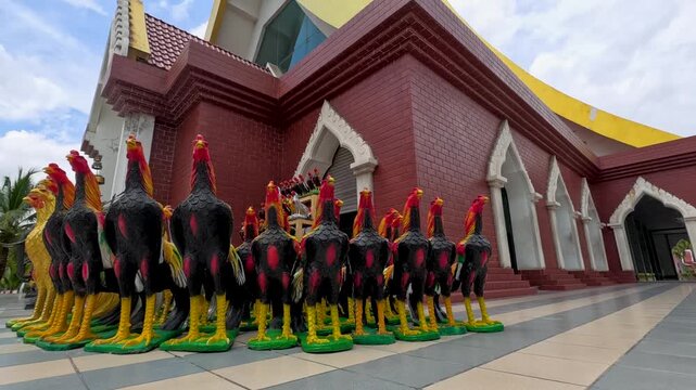 Colorful Rooster Statues Offered at Thai Temple Shrine in Ayutthaya