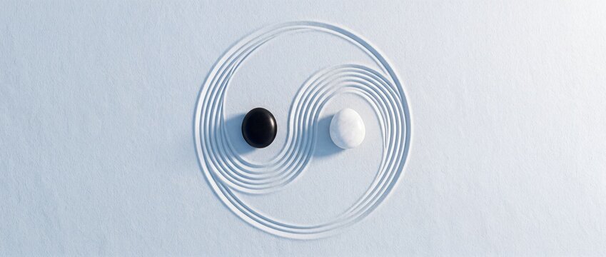 Top-down overhead view of a Yin Yang symbol meticulously raked into white sand with balanced black and white pebbles, representing harmony, zen meditation, and spiritual tranquility in a garden.