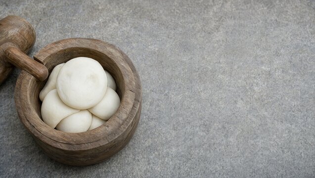 Wooden mortar and mallet with pounded rice cake on an aged stone floor
