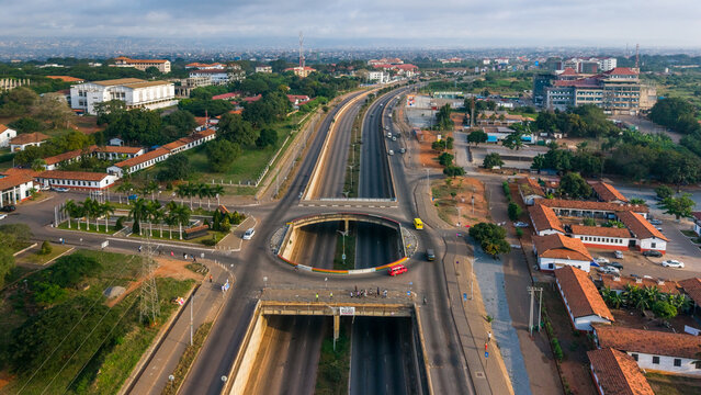 Aerial view of the J.J Rawlings Avenue interchange featuring a multi-level road system, surrounding urban infrastructure, and low-rise buildings in Accra, Greater Accra Region, Ghana.