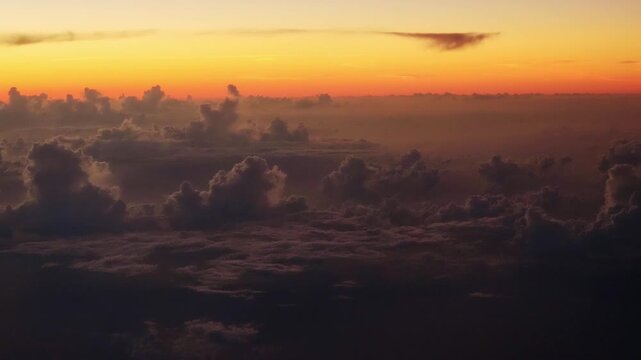 View before sunrise over a dramatic cloudscape taken from a passenger jet.  