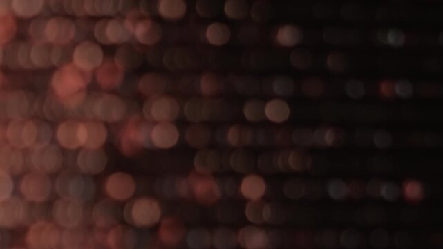 Shimmering dots. Color twinkle blur. Light defocused circles stripes glow fade flicker. Abstract bokeh night luminosity background.