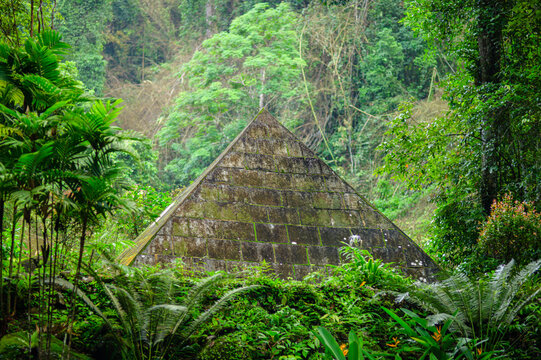 Mysterious Pyramid Structure Surrounded by Dense Rainforest and Greenery