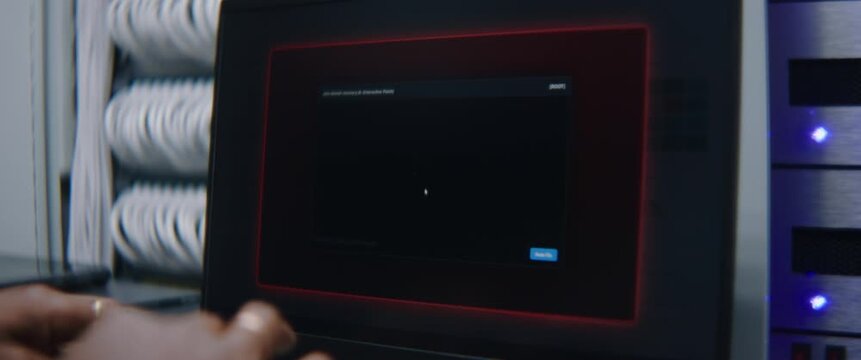 Male Network Engineer Reviewing Operational Data on Desktop Monitor as Critical Failure Notification Appears in Enterprise Server Facility. Hardware Diagnostics, Infrastructure Risk Management, and