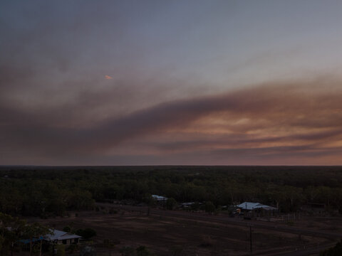 Bushfire smoke in rural sunset sky
