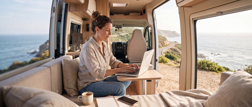 Digital Nomad Working on Laptop from Camper Van by the Ocean