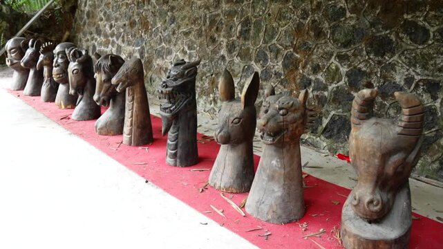 Wooden sculptures of the twelve Chinese zodiac animals arranged in a row in Yangshuo