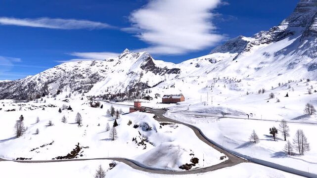 Snow covered Simplon pass in Swiss Alps with drone view of Monte Leone Hotel