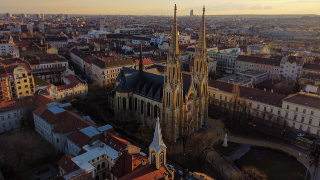 Aerial view of the St. Elizabeth of Hungary Parish Church with its twin spires, surrounded by historic urban architecture and rooftops in Budapest, Hungary.