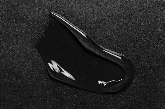 A moisturizer or body gel or a facial serum. Black background.