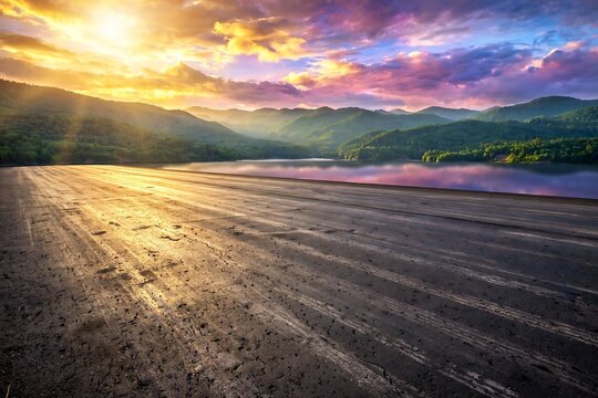 Scenic sunset over a tranquil mountain lake with a dark textured foreground