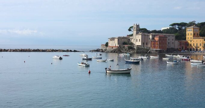 Fishermen boat entering silent bay Sestri Levante. Authentic Italian Riviera coastal aesthetic. Mediterranean summer vacation travel wanderlust.