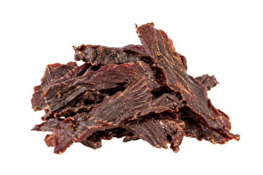 Pile of dark brown dried beef jerky pieces with textured surfaces, isolated on a clean white background
