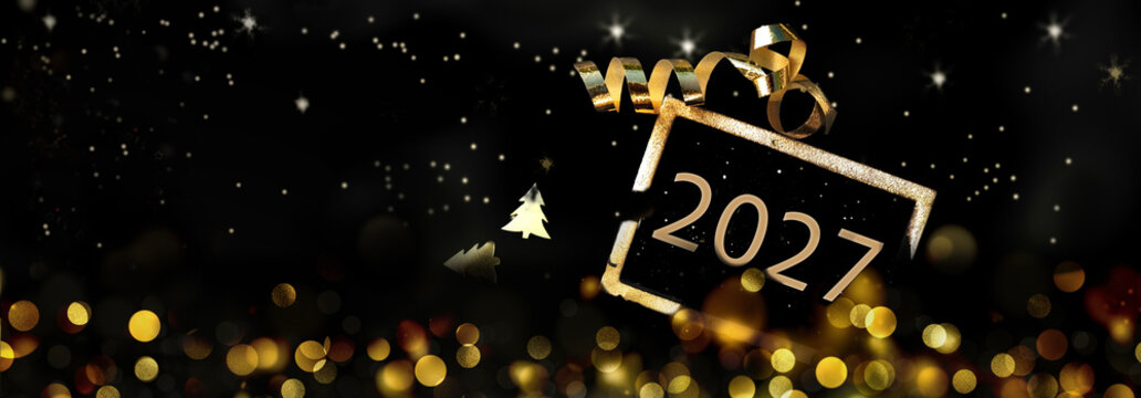 golden 2027 written on  little board on rustic wooden background with golden confetti and ribbon