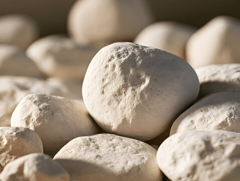 Pale rounded pebbles with a textured stone balanced on top