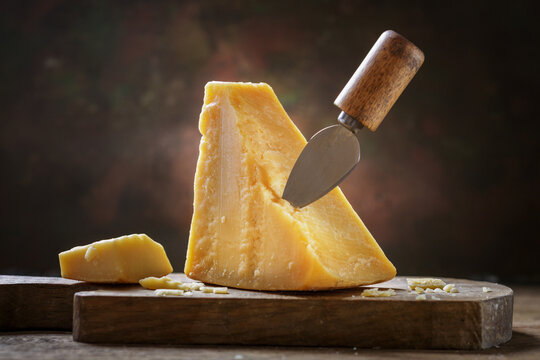 piece of parmesan cheese on a wooden board