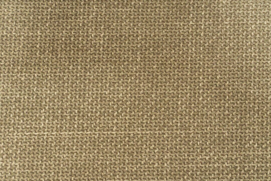 Beige woven fabric texture background with coarse linen weave pattern