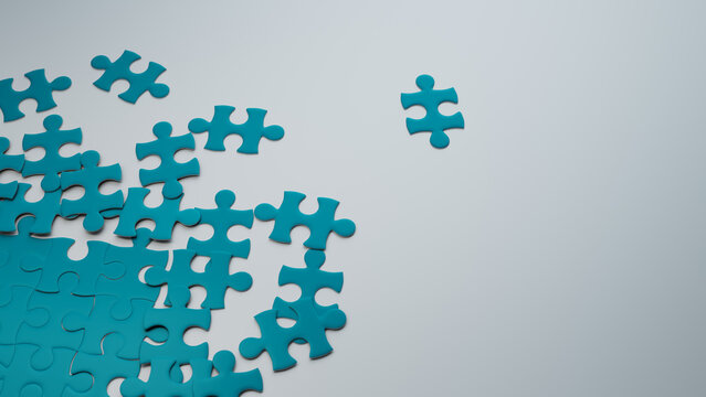 Partially Completed Teal and White Jigsaw Puzzle Wallpaper with scattered Pieces. Analysis Concept with copy-space.