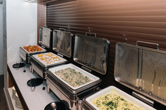 Catering food display with stainless steel chafing dishes at a luxury hotel