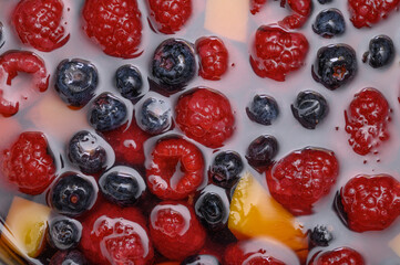 Delicious fruit dessert embedded in jelly, raspberries and blueberries © Paweł Kacperek