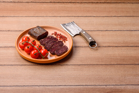 Sliced dry cured beef sausage or basturma with salt and spices. Sliced basturma