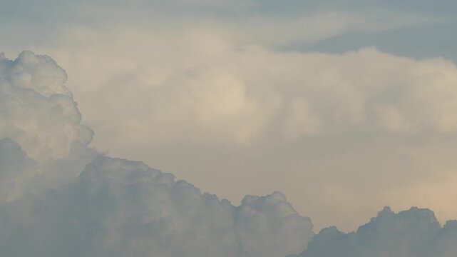 white cumulus cloud against a bright turquoise blue sky dramatic summer minimalist cloudscape background