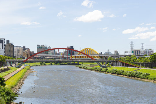 River landscape with arched bridge and urban skyline in taipei city