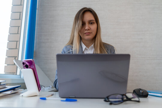 Young attractive businesswoman working on laptop in office