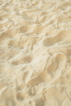 Golden sandy beach dunes texture in Kvarner Bay, Croatia. Concept of summer vacations, coastal nature backgrounds, and relaxation.