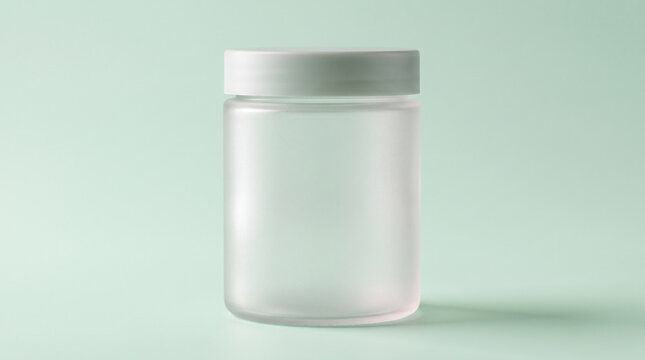 Frosted translucent cylindrical supplement container with minimalist lid, isolated pale mint-green seamless backdrop, modern clean wellness aesthetic. Mockup. Close-up.