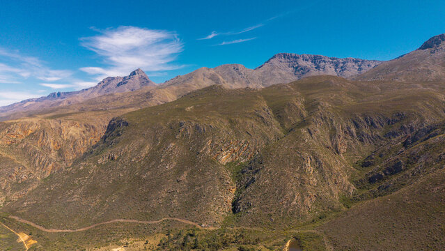 Aerial view of the Swartberg Mountains near Ladismith, featuring rugged slopes, rocky terrain, and the dramatic natural landscape of the Karoo in Western Cape, South Africa.