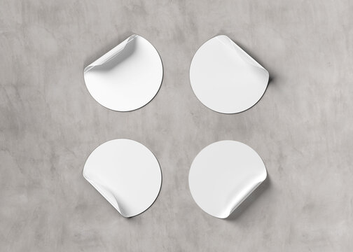 Blank curled stickers collection isolated on concrete. Circular labels mockup. 3D rendering