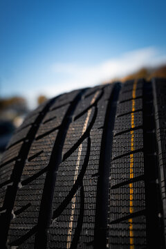 Close Up of New Winter Tire Tread with Yellow and White Factory Markings