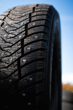 Close Up of Studded Winter Car Tire Tread for Driving on Ice