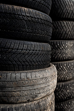 New and Worn Car Tires Stacked Together Showing Tread Wear Differences