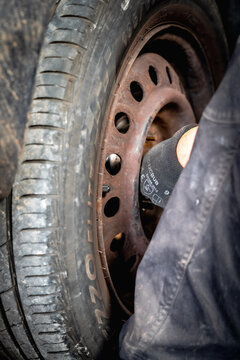 VALMIERA, LATVIA &ndash; OCTOBER 17, 2026: Mechanic Working on a Car Wheel During Seasonal Tire Replacement