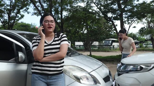 Two young women looking visibly serious used their personal mobile phones contact insurance company requesting arrive promptly resolve the situation.