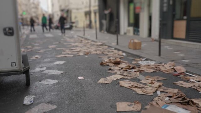 Street littered with paper trash after protest demonstration in paris