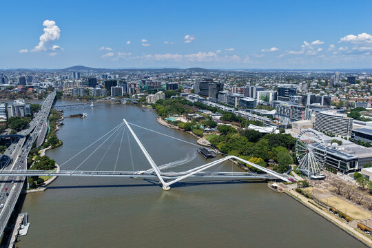 Aerial view of the Neville Bonner Bridge spanning the Brisbane River, with the Wheel of Brisbane and South Bank visible in the cityscape of Brisbane, Queensland, Australia.