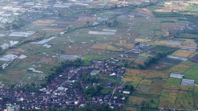 Expansive patchwork of rice paddies and village terraces at Pronojiwo, East Java, Indonesia
