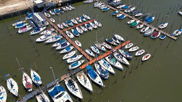 Aerial view of Puerto Olivos with numerous sailboats moored in the marina, featuring wooden docks and calm water in Olivos, Buenos Aires, Argentina.