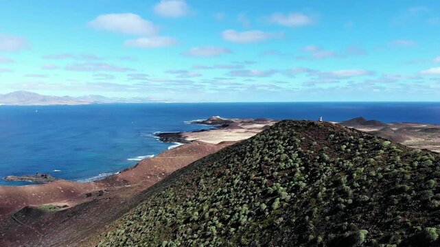 Aerial view over Montana de la Caldera and coast of Isla de Lobos, Fuerteventura, Canary Islands, Spain, Europe. Scenic view of Isla de Lobos with a view of Montana de la Caldera and the coast, Isla d