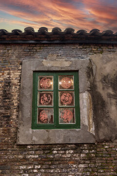 Traditional Jiangnan Residence with Green Window and Sunset Sky